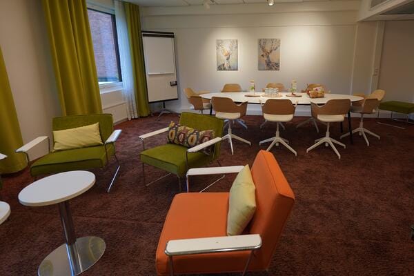 Modern meeting room in Hotel Haaga Central Park, vibrant seating for workshops and brainstorming.