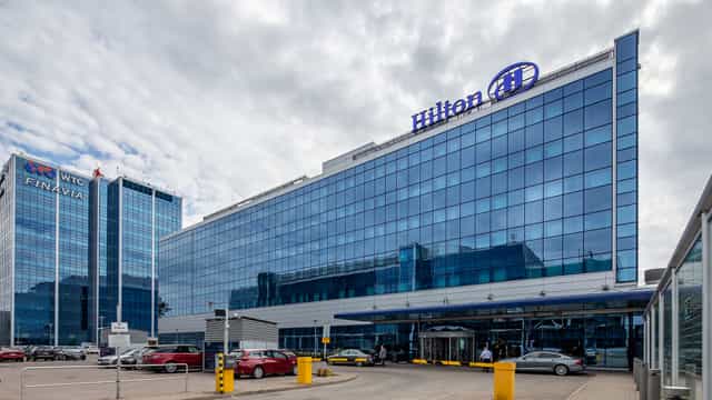 Modern Hilton Helsinki Airport business center with sleek glass facade for events.