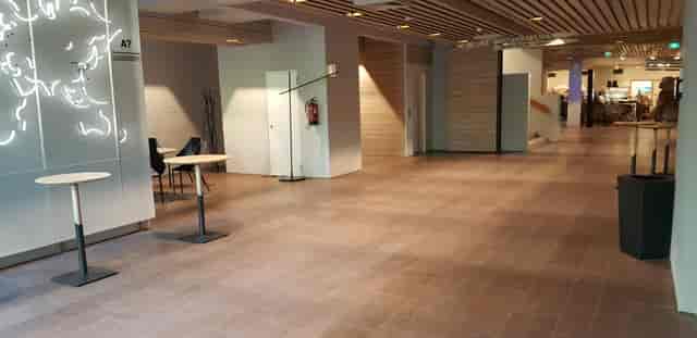 Well-lit event hallway in Lumituuli, Dipoli, ideal for networking and meetings.