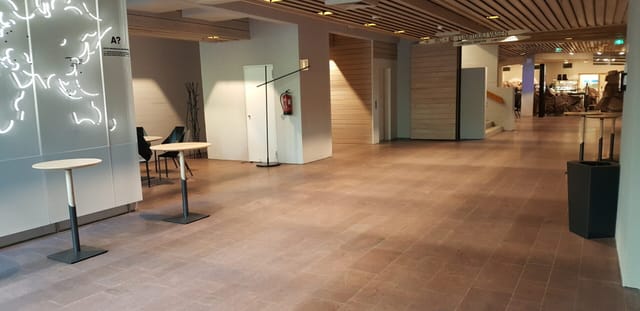 Well-lit event hallway in Lumituuli, Dipoli, ideal for networking and meetings.