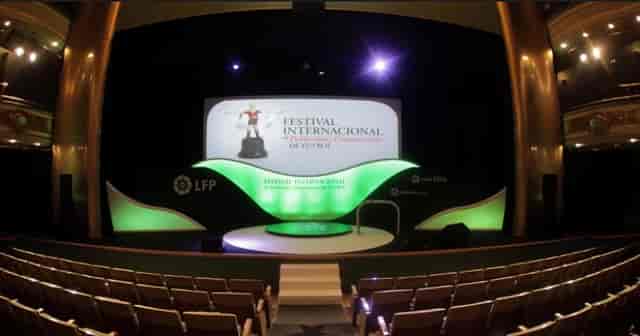 Fernando de Rojas Theatre stage setup with vibrant branding for presentations, award ceremonies.