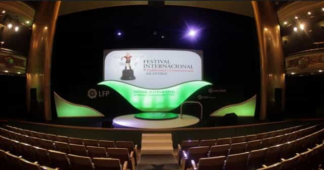 Fernando de Rojas Theatre stage setup with vibrant branding for presentations, award ceremonies.