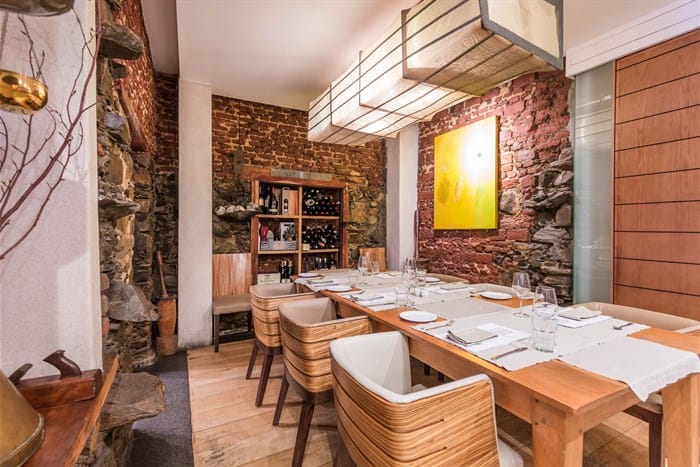 Private dining space with wooden table, ideal for intimate corporate events and meetings.