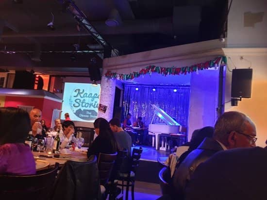 Dinner theater at Rockwell with grand piano and vibrant lighting for memorable events.
