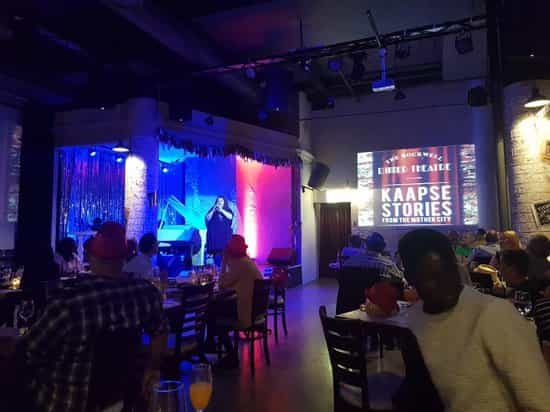 Function room at The Rockwell Dinner Theatre, vibrant setup for Kaapse Stories event.