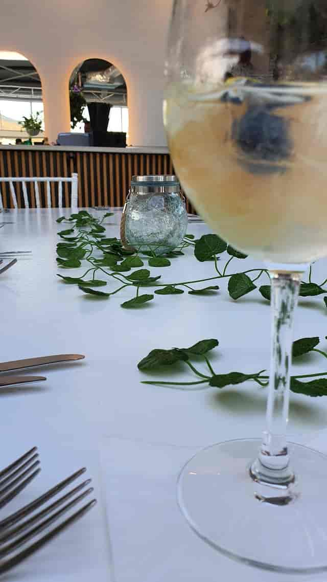 Elegant dining table with greenery centerpiece for garden-themed events on Rooftop.