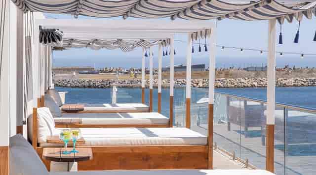 Stylish outdoor lounge at Cabo Beach Club with cabanas, perfect for events and relaxation.