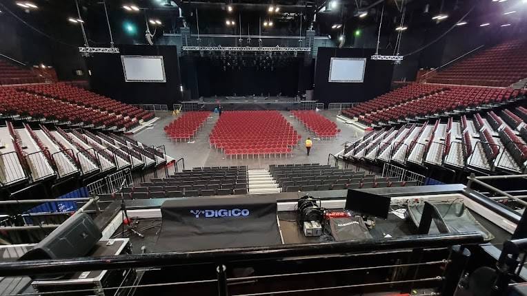 Grand Arena GrandWest event space with red chairs, ready for presentations and performances.