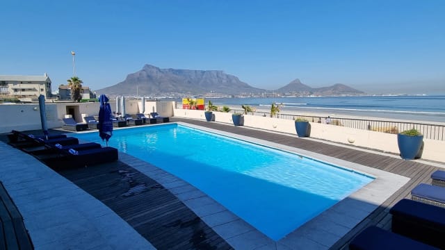 Poolside venue at Lagoon Beach Hotel with Table Mountain view for outdoor events.