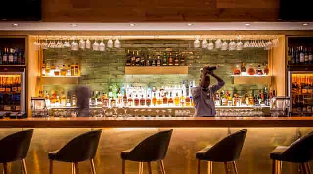 Sleek bar setup in Kove Collection for networking events and VIP receptions.
