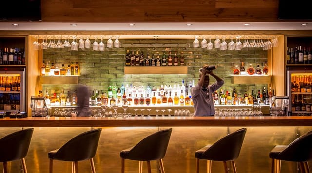Sleek bar setup in Kove Collection for networking events and VIP receptions.