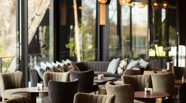 Stylish lounge area with natural light for networking events in Kove Collection.