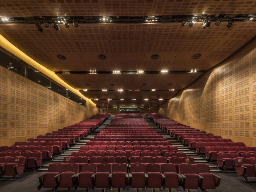 Modern auditorium at CTICC 2, featuring plush burgundy seating for conferences and presentations.
