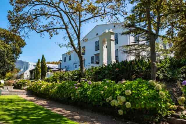 Incognito restaurant at The Alphen: elegant outdoor venue for events amidst lush landscaping.