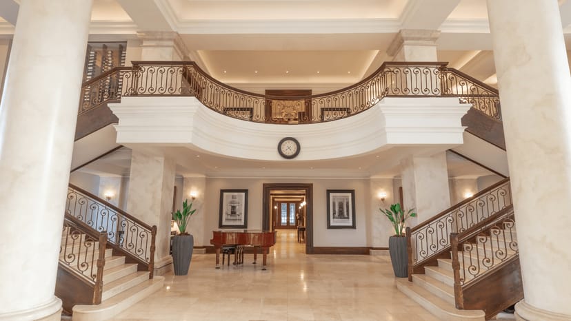 Luxurious hotel lobby with grand staircase, perfect for elegant meetings and events.