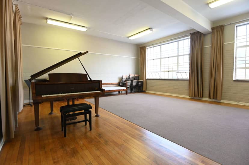 Cape Town Philharmonic Orchestra rehearsal room with grand piano, perfect for musical events.