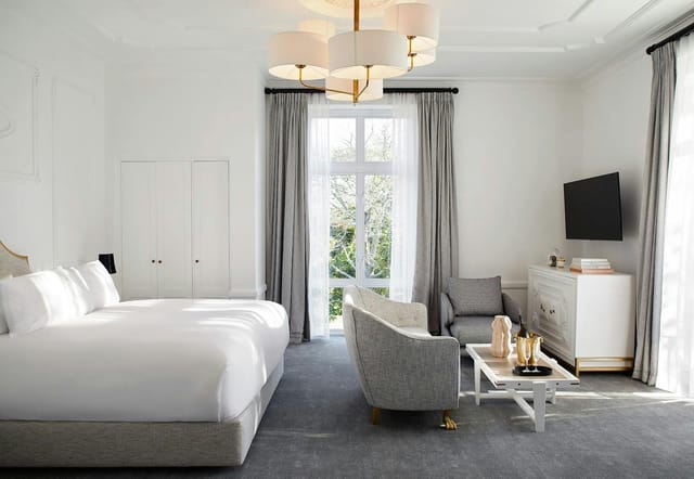 Modern hotel suite at The Alphen for meetings and retreats, featuring ample natural light.