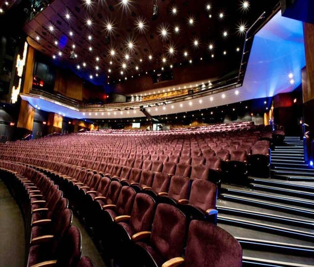 Spacious Artscape Theatre auditorium with plush red seating for events and presentations.