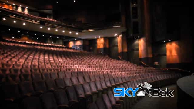 Theatre auditorium with plush seating, ideal for conferences and performances.