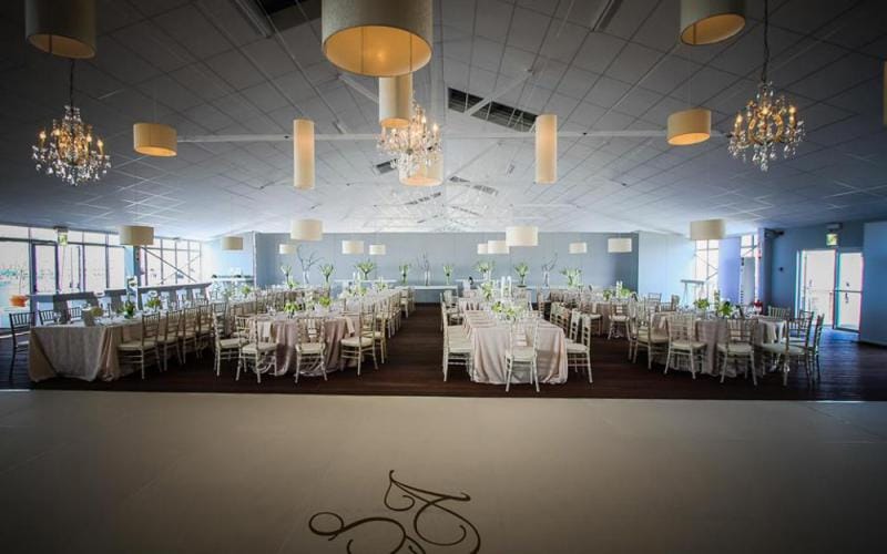 Elegant outdoor terrace venue with beautiful table settings for weddings and events.