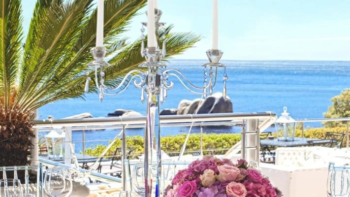 Elegant outdoor dining at Atlantic Marquee, with floral decor and candelabras for upscale events.