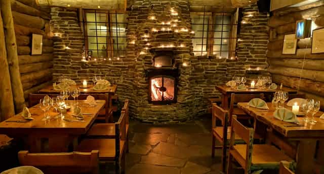 Rustic restaurant dining with cozy fireplace, perfect for intimate gatherings and corporate retreats.