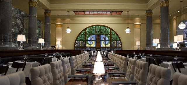 Elegant restaurant interior with plush seating, ideal for upscale corporate events.
