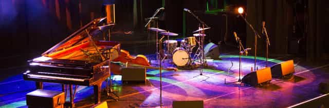 Dynamic Savoy Theatre stage with piano, ideal for live music events and performances.