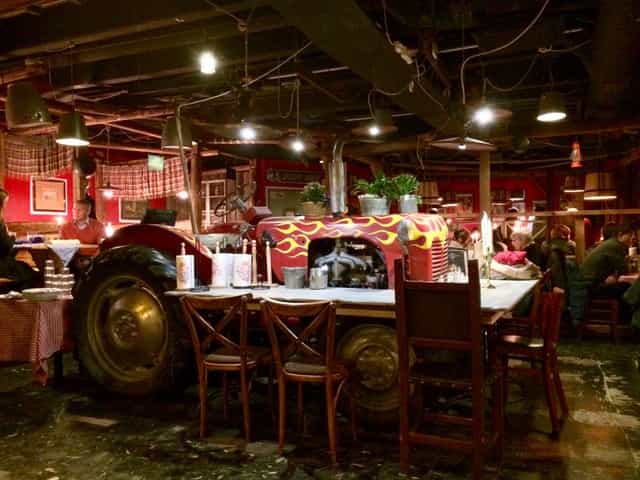 Red tractor centerpiece at Restaurant Zetor, ideal for themed events and networking.