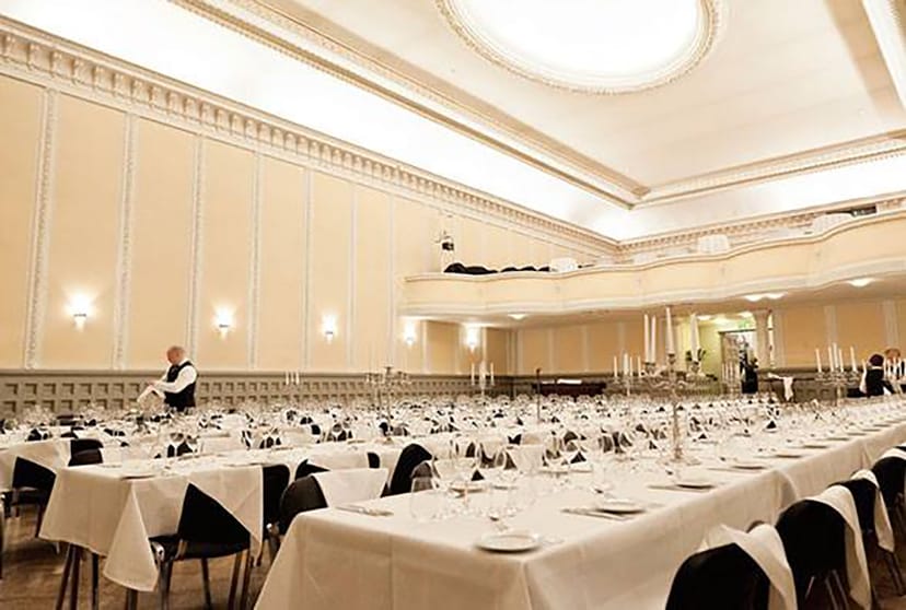 Elegant banquet hall with white linens, ideal for weddings and corporate events.