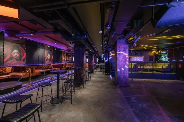 Vibrant NoName Theatre performance area with artistic decor for events and networking.
