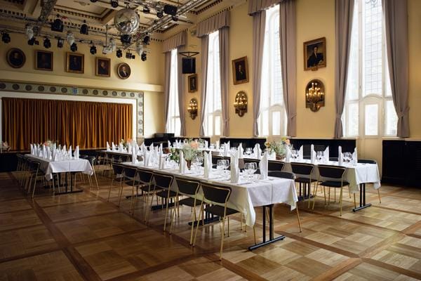 Elegant banquet hall with natural light, perfect for weddings and corporate events.