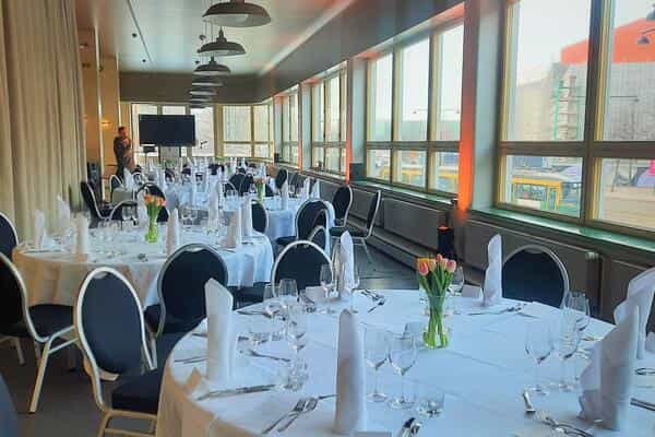 Banquet Hall at Ravintola Töölö with elegant round tables for corporate events.