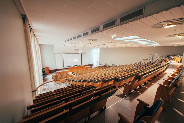 Auditorium Foyer in Ravintola Töölö with tiered seating for corporate events and lectures.
