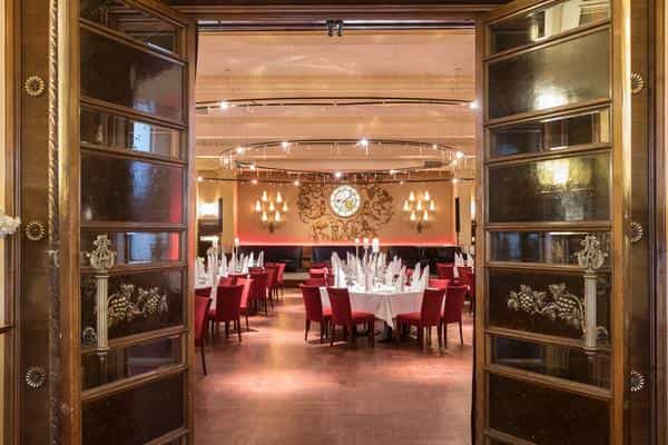 Elegant ballroom dining space with round tables, perfect for corporate events or celebrations.