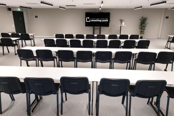 Modern meeting room with black chairs for professional events and workshops.