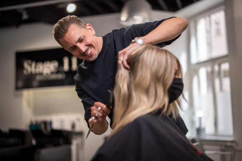 Hairstylist at salon ensuring polished looks for events and networking sessions.