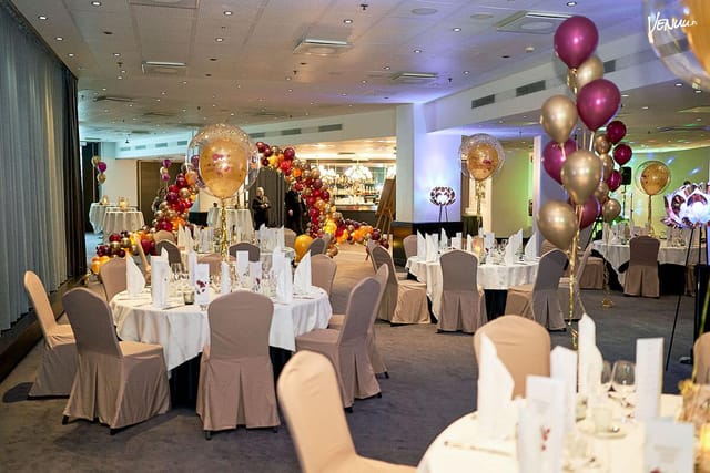 Elegant Hesperia Ballroom banquet setup with balloon arch for weddings and galas.