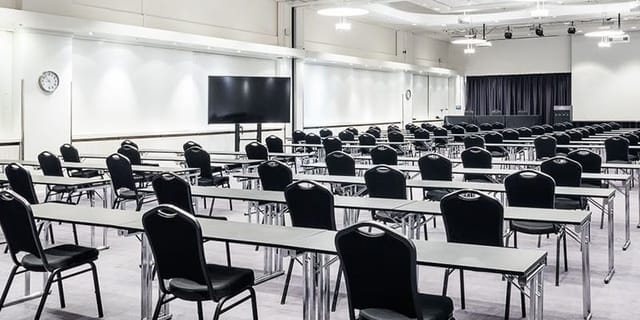 Conference setup in Winter Garden, Crowne Plaza Helsinki - Hesperia, featuring tables and chairs.