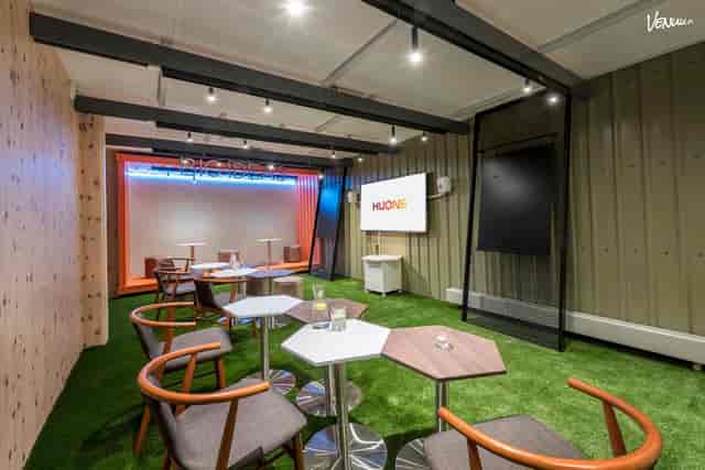 Versatile event space in Kamppi, HUONE Helsinki with artificial grass flooring for meetings.