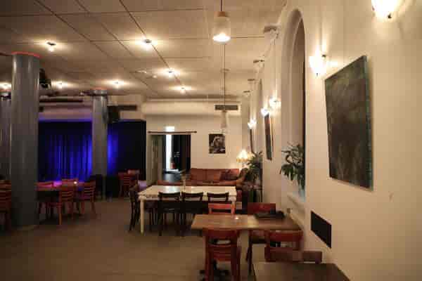 Versatile event space Juhlasali Nostalgia with natural light, ideal for corporate or social gatherings.