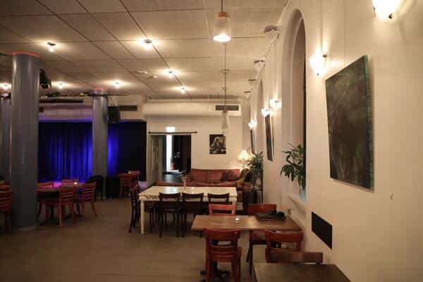 Versatile event space Juhlasali Nostalgia with natural light, ideal for corporate or social gatherings.