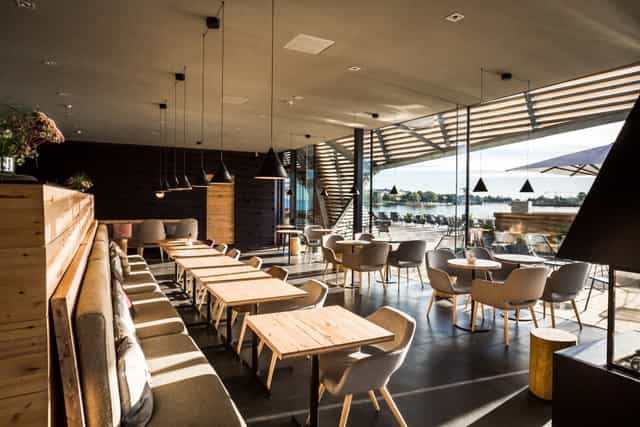 Modern event space in Löyly with natural light, wooden accents, ideal for meetings and workshops.