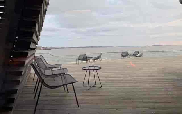 Löyly waterfront deck with sleek seating for relaxed outdoor meetings and networking events.