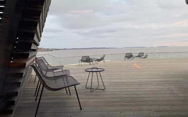 Löyly waterfront deck with sleek seating for relaxed outdoor meetings and networking events.
