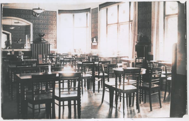 Spacious meeting room with wooden tables in Lehtovaara restaurant for events and workshops.