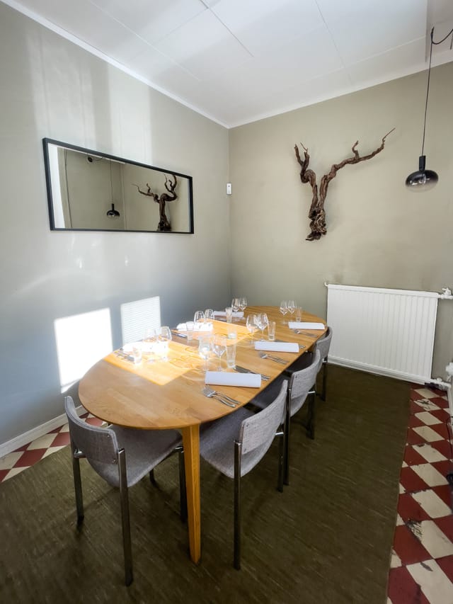 Intimate meeting space with round table, ideal for client meetings and private dinners.