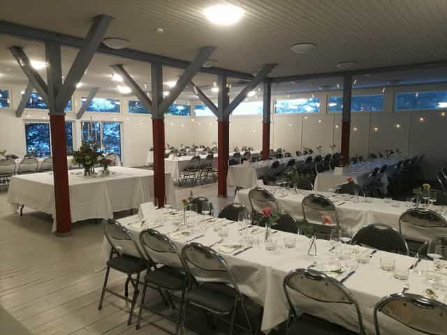 Elegant event venue Ateljé Hall with long tables, ideal for weddings and corporate events.