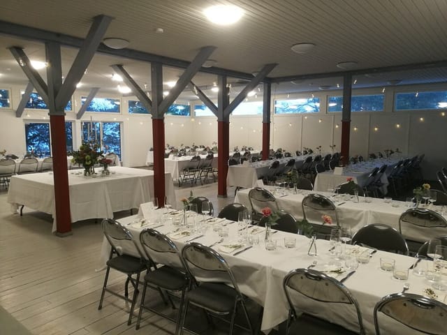 Elegant event venue Ateljé Hall with long tables, ideal for weddings and corporate events.