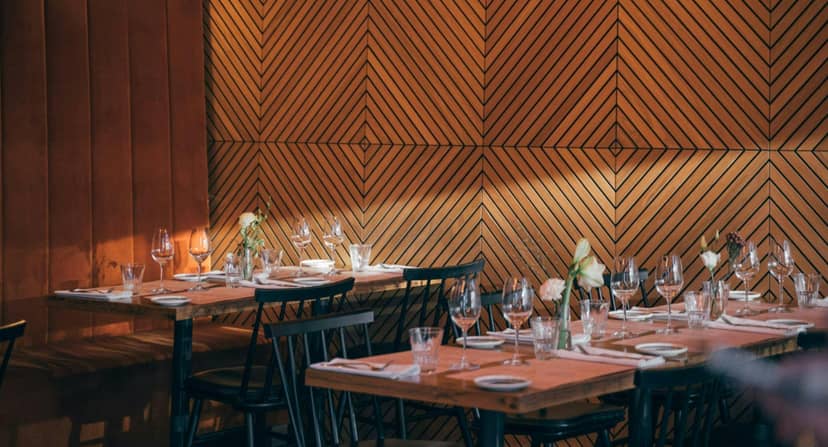 Stylish dining area with cozy wood tones, perfect for intimate gatherings or events.